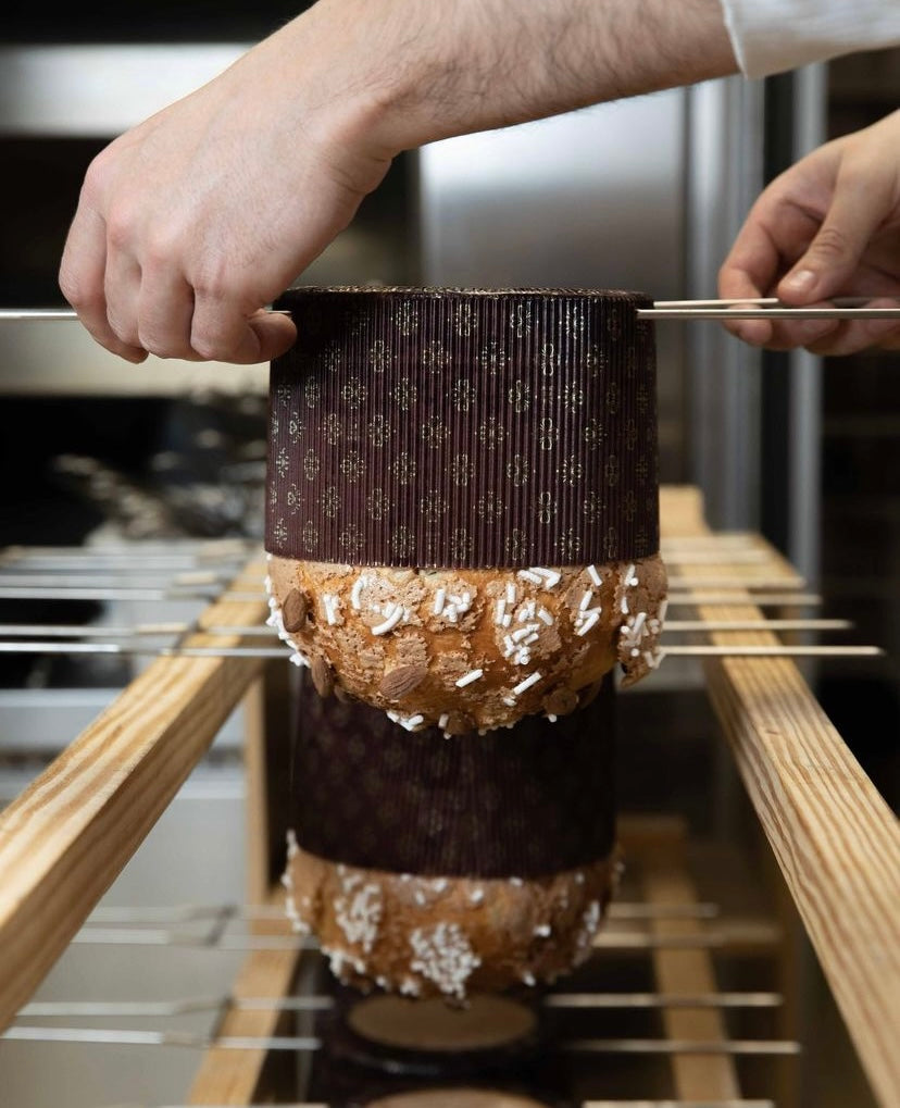 Why do panettone hang upside down after baking?